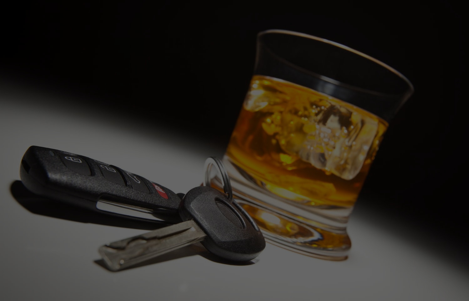 car keys and glass with alcohol